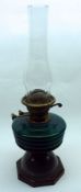 A late 19th/early 20th Century Oil Lamp, the octagonal metal base to a turquoise glass font, brass