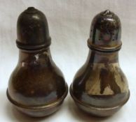 A pair of George V small Silver baluster Condiments (Salt and Pepper) of circular baluster form,