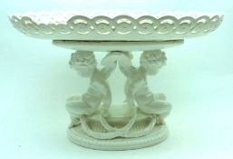 A European Blanc-de-Chine Oval Pedestal Tazza, raised on cherub-shaped supports, 13” wide (A/F)