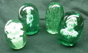 A collection of four Nailsea green glass dump shape Paperweights, all approximately 5” high