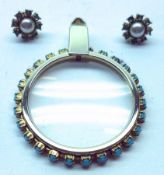 A Gold Plated Circular Pendant Magnifying Glass with turquoise coloured stones in surround, 33mm