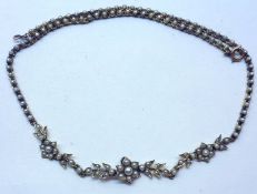 An Edwardian period mid-grade precious metal (unmarked) Decorative Necklace, set throughout with
