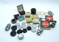 A Box containing mostly Leica parts and accessories, to include: Light Meters, Numerous Lens Caps,