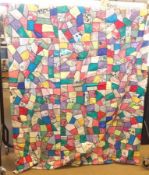 A handmade Crazy Patchwork Quilt in brightly coloured silky fabric, each section joined together