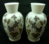A pair of late 19th/early 20th Century French Opaque Glass Vases decorated with floral sprays on a