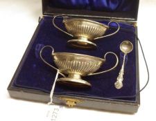A cased pair of Edwardian boat shaped Salts, half fluted decoration, looped handles, oval bases,