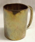 A George V Christening Tankard of plain cylindrical form, with hollow looped handle, (minor dents