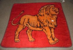 An early 20th Century Pony Trap Knee Rug, red Mohair ground, with central lion motif, black Wool