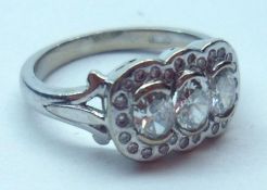 A hallmarked 18ct White Gold Dress Ring set with three oval cut Diamonds, approximately ¾ cts total