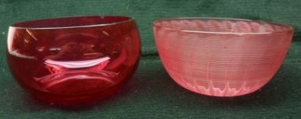 Five Cranberry Glass Finger Bowls of typical squat form; together with a further ribbed Cranberry