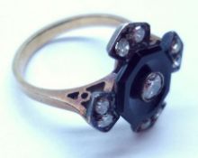 An art deco period black Onyx and Diamond centre Cluster Ring of open design, featuring four further