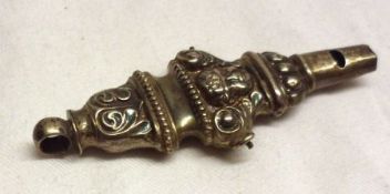 An Edwardian Childs Whistle/Rattle (bells missing), embossed with angelic faces, 3 ¼” long,