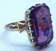 An antique Gold Ring set with a purple stone with enamelled figurative decoration