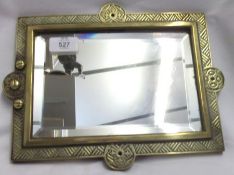 A Cast Brass framed Wall Mirror of rectangular form, the frame embossed with geometric designs, with