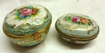 A circular Ceramic Box with gilt metal framed hinged lid, gilded and hand painted with a bouquet