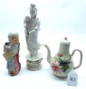 A small Oriental Blanc de Chine Figure of a Geisha clutching a flower bud (one hand missing); a