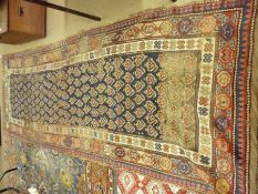 A Caucasian Carpet with triple gull border, central panel of geometric designs, mainly blue, red and