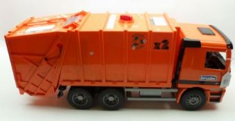 A large modern Bruder Recycling Refuse Truck, orange hard plastic construction, length 25”