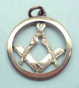 An early 20th Century yellow metal Masonic Pendant, of circular shape with engraved compass and