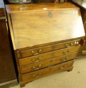 An early 19th Century Mahogany Bureau of typical form, the sloped front opening to reveal an