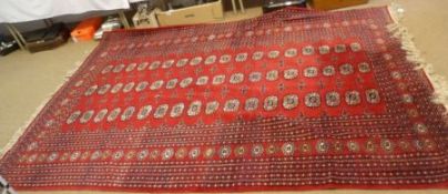 A modern Shiraz Carpet, multi gulled border and central panel of lozenges on a red field, 9’ x 6’