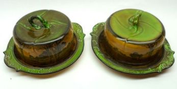 A near pair of Royal Doulton Round Covered Cheese or Butter Dishes, decorated with a continuous
