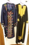 A full length Black Linen Ladies Kaftan, extensively decorated with gold embroidery; together with a