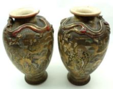 A pair of early 20th Century Satsuma Baluster Vases, the necks moulded with dragons and decorated