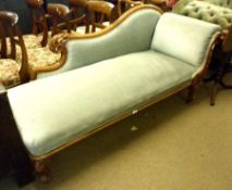 A Victorian Faded Mahogany Framed Chaise Longue, the swept body upholstered in blue fabric, raised