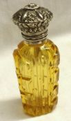 A Victorian Amber glass Scent Bottle of shaped oval section with heavily carved detail, hinged