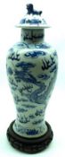 An Oriental Baluster Vase painted in underglaze blue with four-toed dragons and smoke clouds (