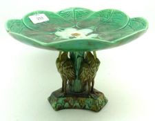 A late 19th Century Majolica Pedestal Tazza, the top formed as water lily pads and flower, supported