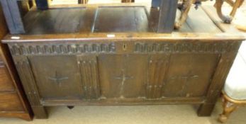 An 18th Century Oak Coffer with plain three panelled top, the front with dentil type chip carving