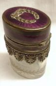 An Edward VII Continental Silver gilt and enamelled Toiletry Bottle, the oval clear cut glass bottle