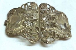 An art nouveau styled two-part Buckle, pierced with foliate and scroll designs, 3 ¼” x 2 ½” overall,