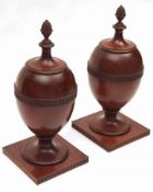 A pair of early 19th Century Wine Coolers of urn form, the lids with carved pineapple shaped