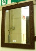 A rectangular Wall Mirror in a foliate carved Oak Frame, 17 ¾” wide