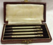 A cased set of four Bridge Pencils, with (partial) decals to the finials, stamped “Sterling”