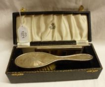 An Elizabeth II Childs Silver backed Hairbrush with engine turned decoration plus a matching