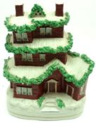 A Staffordshire Flatback Money Box, modelled as a snow-covered three storey house, decorated in