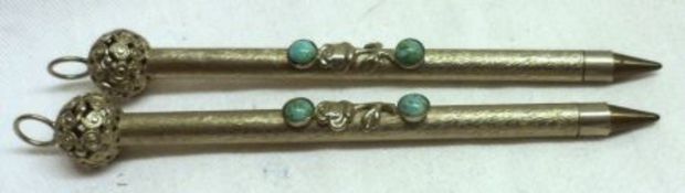 A pair of 20th Century metal cased Ballpoint Pens with decorative pierced finials and turquoise