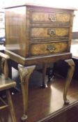 A reproduction Walnut and Mahogany Bedside Cabinet with cross banded top and moulded edge and