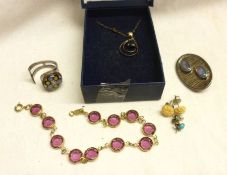 A packet of assorted items including boxed blue stone Pendant, purple stone Bracelet and other