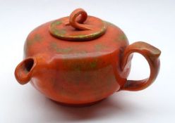 A Barnstaple Teapot, decorated in mottled green and orange with side handle, incised mark to base,