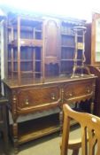 An Oak Dresser in the Jacobean style, top section with central panelled door and three shelves