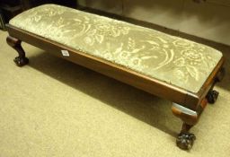 An early 20th Century Rectangular Mahogany Framed Footstool with green floral push-out seat raised