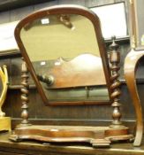 A Victorian Mahogany Swing Mirror, with arched mirror back raised on twisted columns terminating