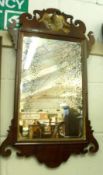 A Georgian Mahogany Fretwork Framed Wall Mirror, the top with gilded ho ho bird mount, the mirror