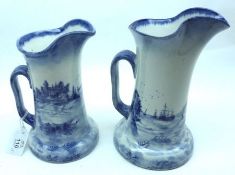 Two Doulton Burslem “Norfolk” pattern Jugs, typically decorated in blue, the largest 7 ½” high (2)