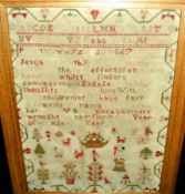 A 19th Century Needlework Sampler decorated with rows of letters, numbers and extensive religious